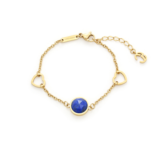 Gold bracelet with a blue lapiz lazuli  gemstone on a white background