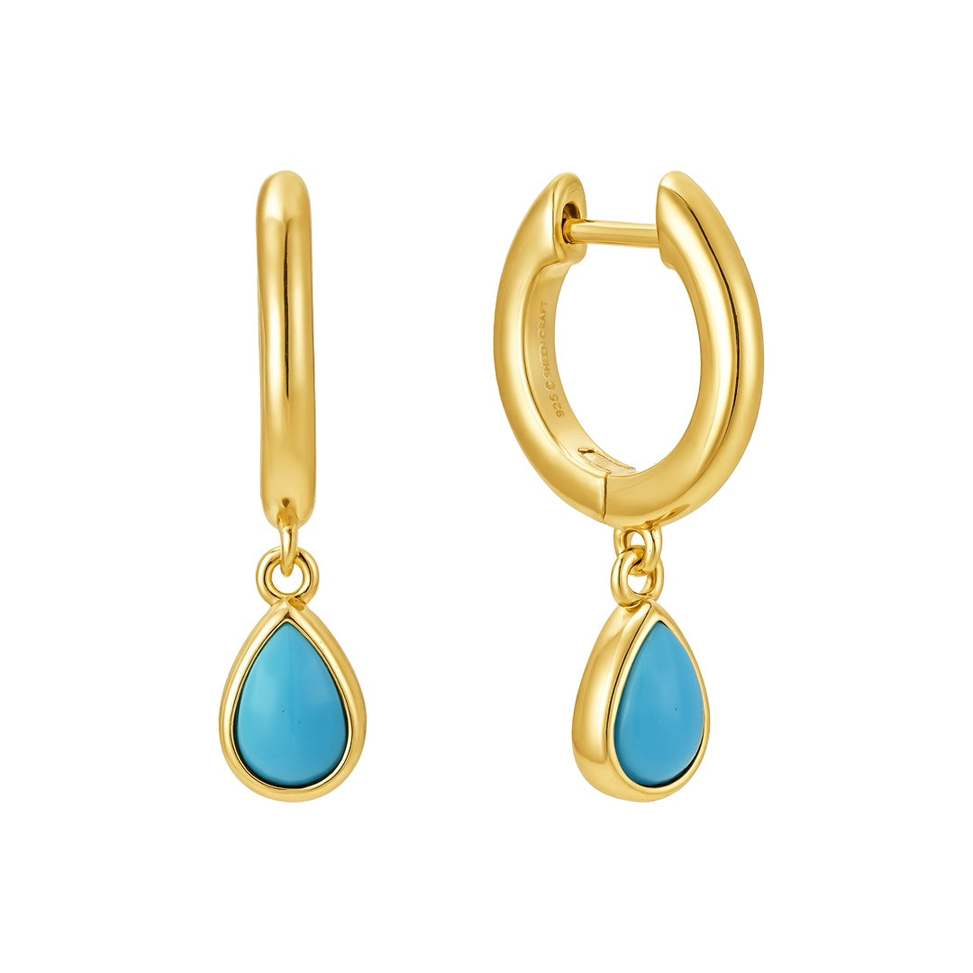 Gold hoop earrings with turquoise teardrop charms on a white background